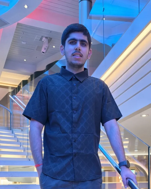 Om Israni, founder of BlankCanvas Software, standing on a lit staircase